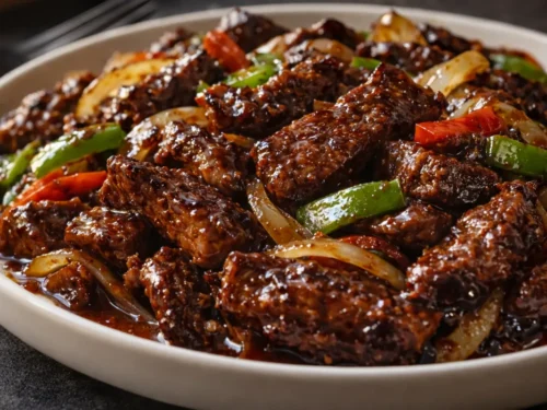 A Sizzling Pan Of Chinese Pepper Steak With Tender Beef Strips And