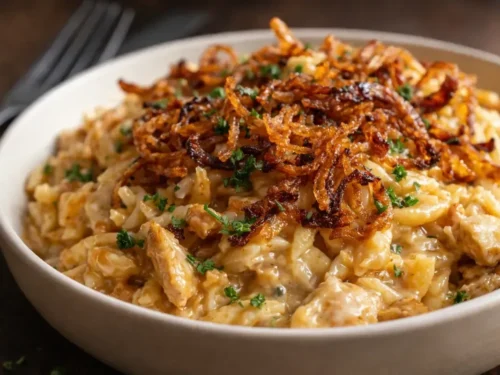 A Skillet Of Creamy French Onion Chicken Orzo Topped With Melted Golden