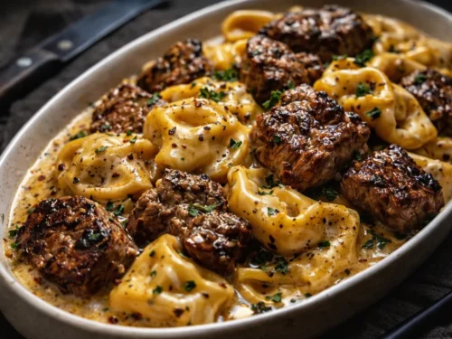 A Skillet Of Garlic Steak Tortellini With Seared Steak Bites And Creamy