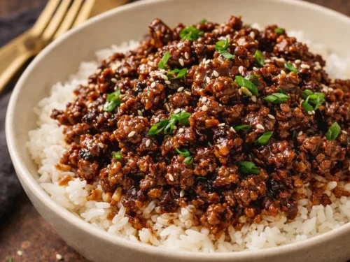A Delicious Korean Ground Beef Bowl Topped With Green Onions And Sesame